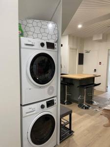 a kitchen with two washing machines in a wall at Cozy 2 Bedroom with Parking in Toronto