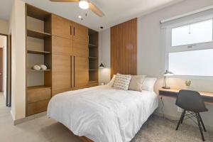 a bedroom with a bed and a desk and a window at Akumal Skies Private Terrace W Jacuzzi W Sea Views Walk To Beach in Akumal +33 photos