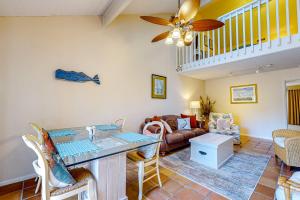 a living room with a ceiling fan and a couch at Nature Retreat in Seabrook Island