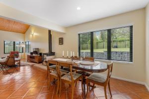 a dining room with a table and chairs at Modern Barn Style - Taupo Holiday Home in Kinloch