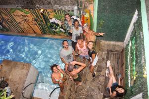 a group of people posing in front of a swimming pool at Bamboo Rio Hostel in Rio de Janeiro