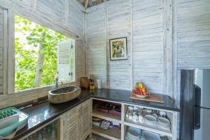 a kitchen with a sink and a window at Villa Sungai Laut in Canggu +20 photos
