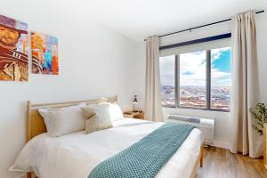 a bedroom with a bed and a large window at Pioche Village #1226 in Park City