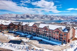 an aerial view of a resort with snow covered mountains at Pioche Village #1226 in Park City