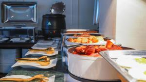 a kitchen with several trays of food on a counter at Sugar Marina Hotel - FASHION - Kata Beach in Kata Beach