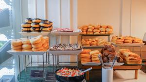 a display case with different types of donuts and pastries at Sugar Marina Hotel - FASHION - Kata Beach in Kata Beach