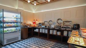 a kitchen with a refrigerator in a restaurant at Sugar Marina Hotel - FASHION - Kata Beach in Kata Beach