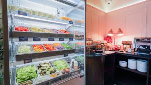 an open refrigerator filled with lots of fruits and vegetables at Sugar Marina Hotel - FASHION - Kata Beach in Kata Beach