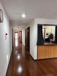 a hallway of a house with a room with a counter at Shofusha Lodge Madarao Tangram in Madarao Kogen