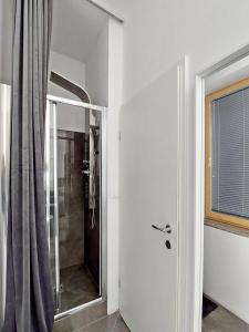 a bathroom with a shower and a glass door at Sunny terraces ROSE VALLEY, Ljubljana in Ljubljana