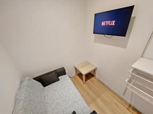 a living room with a couch and a tv on the wall at Sunny terraces ROSE VALLEY, Ljubljana in Ljubljana