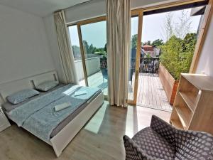 a bedroom with a bed and a view of a balcony at Sunny terraces ROSE VALLEY, Ljubljana in Ljubljana