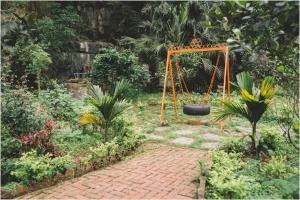 a playground with a swing in a garden at Trang An Mountain House - The Heart of Heritage in Ninh Binh +102 photos