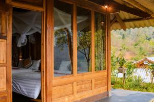 a wooden room with a bed inside of it at Hoa Lan Bungalow & Restaurant in Phong Thổ