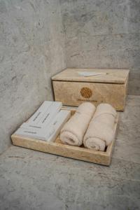 two boxes of towels on a wooden tray at Ocean Paradise Bali in Buleleng