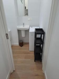 a bathroom with a sink and a mirror and a shelf at Nidito Enamorados in Pamplona