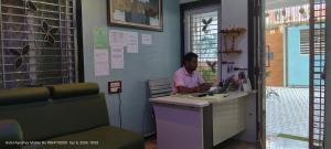 a man is sitting at a counter in a room at HOTEL AYODHYA PAYING GUEST in Ayodhya