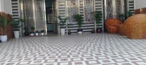 a patio with potted plants and a chair on a tile floor at HOTEL AYODHYA PAYING GUEST in Ayodhya