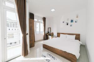 Postel nebo postele na pokoji v ubytování Mat Troi Vang Dalat Hotel + 37 fotografií