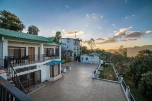 a view of a balcony of a house at Arkaya Mukteshwar by SuperGlitz Resorts Pvt Ltd in Mukteshwar +37 photos