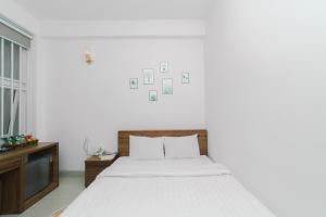 Postel nebo postele na pokoji v ubytování Mat Troi Vang Dalat Hotel