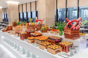 a display of fruits and vegetables in boxes on a table at Awaken Da Nang Hotel in Danang