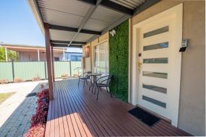 a porch with a table and chairs on it at 29 in Corio