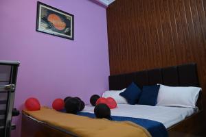 a bedroom with a bed with balloons on it at HOTEL AYODHYA PAYING GUEST in Ayodhya