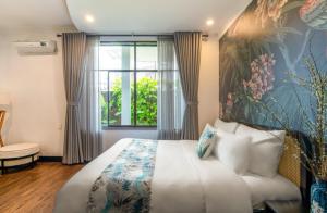 - une chambre avec un grand lit et une fenêtre dans l'établissement Villa Đà Nẵng Gần Biển - Biệt Thự Đà Nẵng, à Đà Nẵng