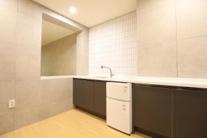 a kitchen with a sink and a counter top at Hotel Intro in Busan