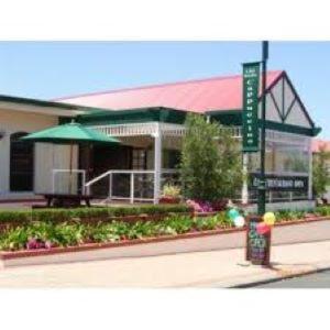 a building with a sign in front of it at Augusta Hotel Motel in Augusta