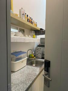 a small kitchen with a sink and a counter at South Residences in Manila