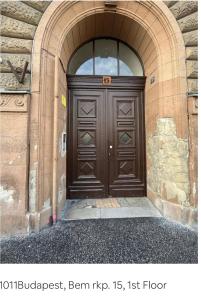 a large wooden door in a building with an archway at Buda Castle Charming 2 bedrooms in Budapest