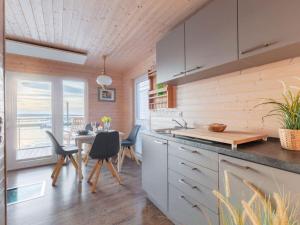 a kitchen and dining room with a table and chairs at The Goose Modern Retreat in Burgstaaken