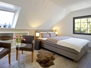 a bedroom with a bed and a table and a window at La Maison Titisee Boutique Design in Titisee-Neustadt