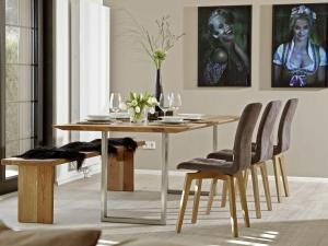 a dining room with a wooden table and chairs at La Maison Titisee Boutique Design in Titisee-Neustadt