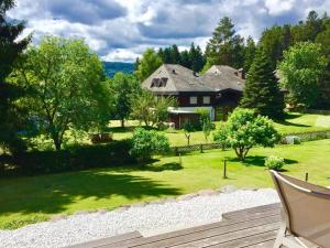 a house sitting in the middle of a yard at La Maison Titisee Boutique Design in Titisee-Neustadt