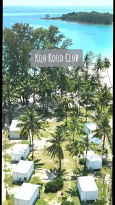 a view of a resort with palm trees and the ocean at Koh Kood Club in Ko Kood