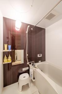 a bathroom with a toilet and a bath tub at LANDMARK NAMBA EBISUCHO chan in Osaka