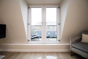 a living room with a window and a chair at Casablanca 18 - Cardiff Bay - 2 Bed Apartment in Cardiff