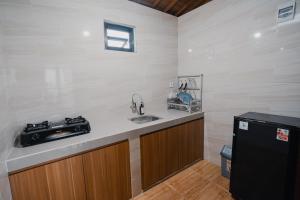 a kitchen with a sink and a stove at The Akasea Villa Bali in Ungasan