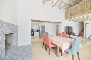a dining room with a table and chairs and a fireplace at House 15 A Kassiesbaai in Arniston