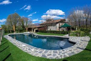a swimming pool in the yard of a house at Podere Brughee in Tremezzo