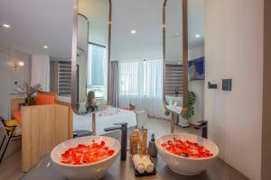 two bowls of vegetables on a counter in a room at PĀMA Boutique Hotel and Bistro in Danang