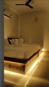 a bedroom with a bed with lights on the floor at La Shashalia Luxury in Puducherry