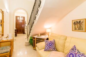 - un salon avec un canapé et un escalier dans l'établissement Sunny Maltese townhouse Madonnina Kalkara - Happy Rentals, à Kalkara