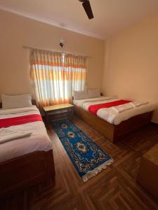 Vuode tai vuoteita majoituspaikassa Hotel Global Inn
