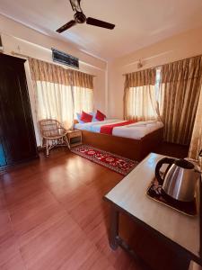 a hotel room with a bed and a table at Hotel Global Inn in Pokhara
