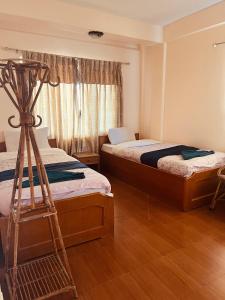 Vuode tai vuoteita majoituspaikassa Hotel Global Inn