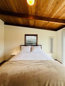a bedroom with a large bed with a wooden ceiling at Pacific Sands Vacation Home in Fort Bragg